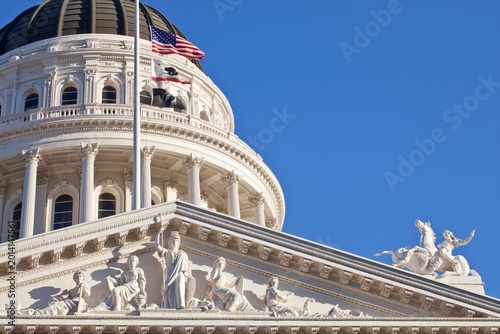 California State Capitol Building with American and California flags, Sacramento.