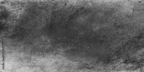 A dark vintage grunge texture background featuring an aged black and white rough surface with distressed grey concrete and stone pattern design