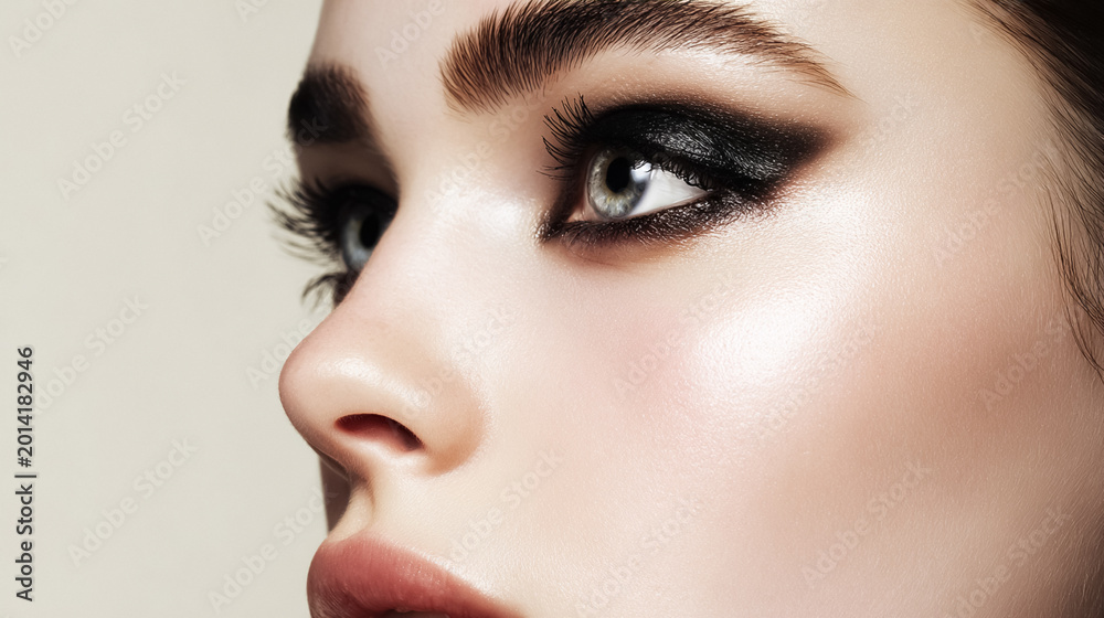 Fototapeta premium Woman wearing dramatic smoky eye makeup, showcasing beauty, fashion cosmetics, and professional evening style
