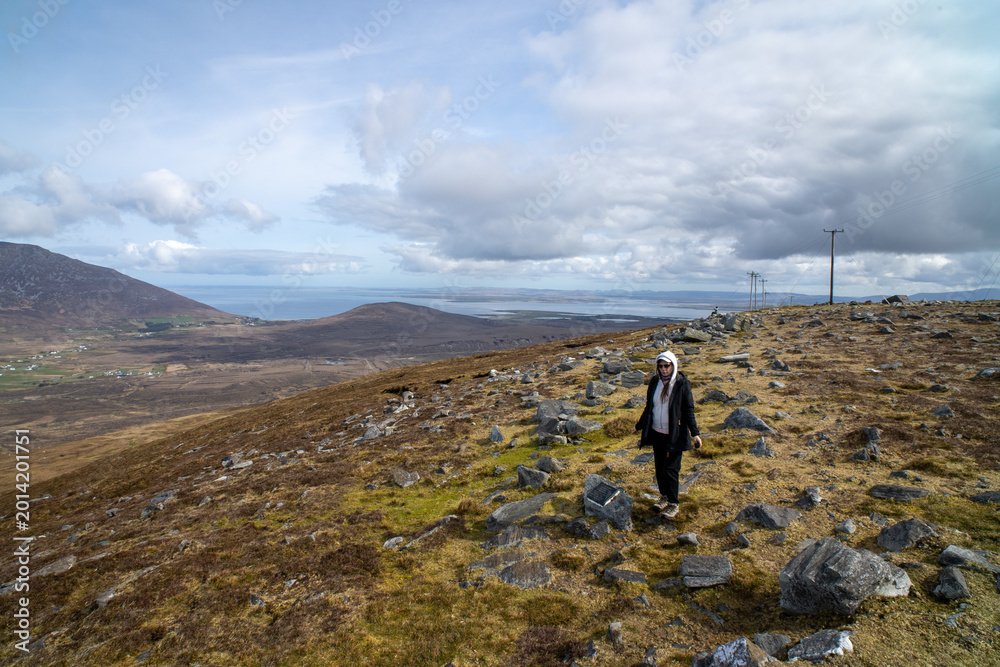 Fototapeta premium Woman Walks Through A Wide Mountain Landscape