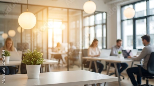modern office interior with blurred people working at desks and a small potted plant in foreground high quality professional detailed elegant stylish clean crisp