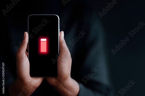 Phone displays low battery warning, showing reliance on digital devices today