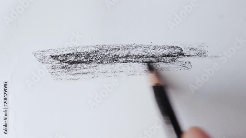 close up of charcoal pencil drawing on textured paper. slow motion footage. Background video can be used as overlay. doodling hatching
