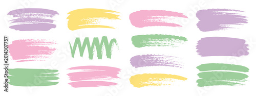 Collection of pastel colored paint brush strokes and scribbles on white background