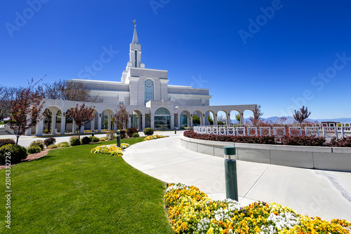 Bountiful Utah Temple Exterior View with Blue Sky Spring flowers and Green Landscaping on a Sunny Day