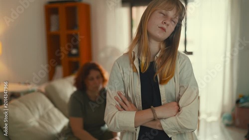 Frustrated teen daughter arguing with mother at home