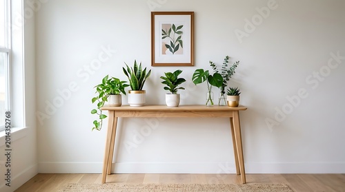 Stylish wooden console table displaying various potted houseplants and framed artwork