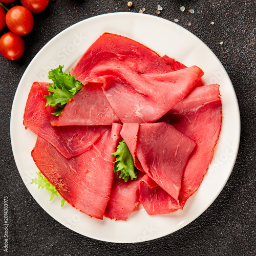 Beef ham thin slices of veal ham meat dish lunch or dinner tasty snack fresh, delicious, gourmet food background on the table rustic food close-up copy space