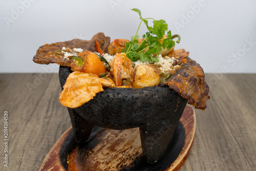 Fényképezés Sizzling hot molcajete full of carne asada, shrimp, seafood to satisfy that urge