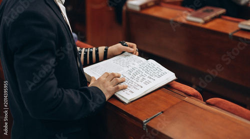 Jewish Prayer with Tefillin and Open Torah