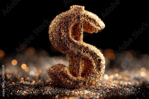 Shiny dollar symbol made of glitter against a dark background with scattered sparkles