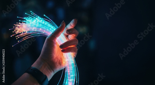 Hand holds vibrant fiber optic cables showcasing technology and innovation in AI and software