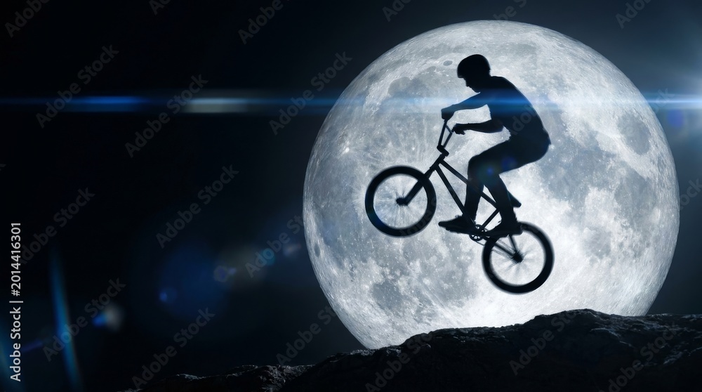 Fototapeta premium Professional BMX rider performing an aerial tailwhip against a giant supermoon