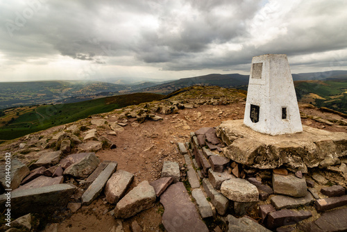Konstfotografi Trigonometry point on the rocky summit of Sugarloaf mountain in Abergavenny Wale