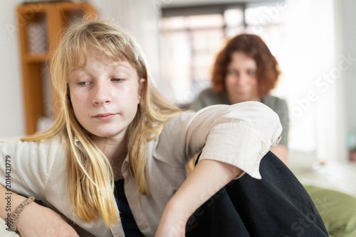 Canvas Print Teenager expressing sadness ignoring mother's presence at home