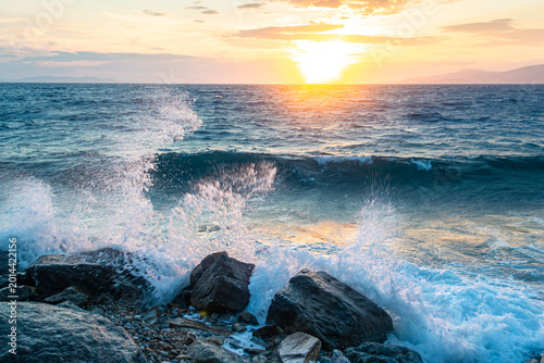 Photography Powerful sea waves crashing on rocks during sunset in Greece