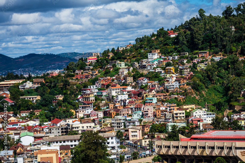 Fototapeta premium Hillside residences in Antananarivo clustered on a steep green slope