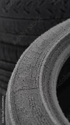 Frozen car tire tread in winter conditions close up