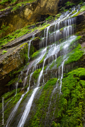 A view of a waterfall cascading down rocks in Wimbachklamm, a popular travel spot in Ramsau, Germany.