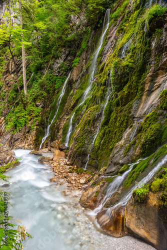 Visitors can explore the lush green landscape and flowing water in Wimbachklamm, Ramsau, Bavaria