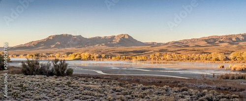 Obraz na płótnie Pahranagat Lake Nevada at Golden Hour with Desert Mountains and Autumn Trees