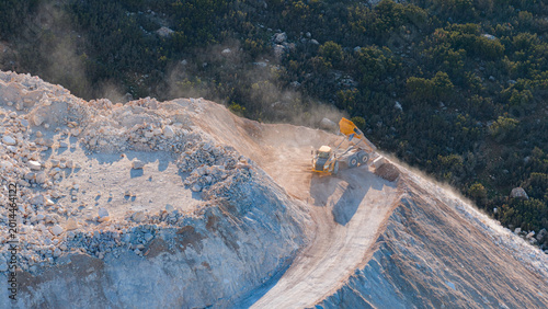 Slika na platnu Marble Quarry Scene: A dump truck unloading material on a quarry slope, creating a cloud of dust