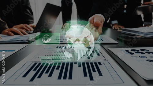 Foto A business team engages in strategic planning and analysis using financial charts and digital overlays, capturing global market trends in a modern office setting