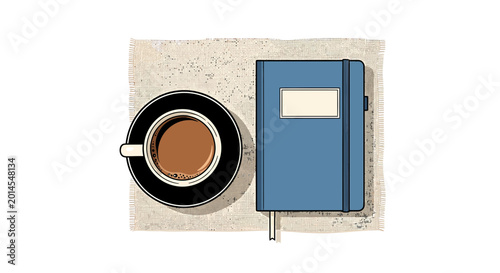 Top view of a coffee cup beside a blue notebook on a linen placemat