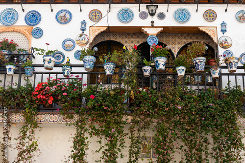 traditional Andalusian house decorated with ceramic plates and flowers in the historic Albayzín neighborhood of Granada, Spain