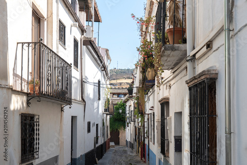 Narrow street scene with residential buildings in Granada, Spain