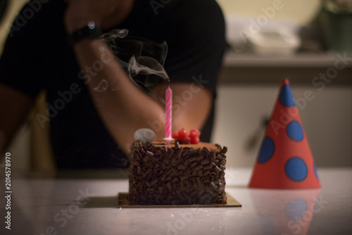 Tableau sur toile Lonely person celebrates birthday alone at home with candle extinguished