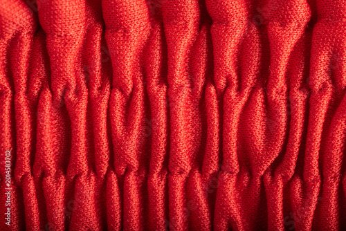 Obraz na płótnie Close-up of red pleated fabric texture with gathered elastic smocking detail