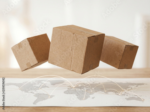 Cardboard boxes floating above a world map with glowing connection lines