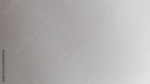 Abstract gray paper texture background with subtle grain and soft lighting, minimal neutral surface for design templates and modern backdrop use