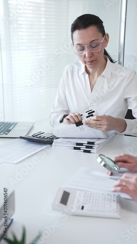 Accountants working together calculating taxes and auditing financial reports in a busy office setting. Audit and taxes in business