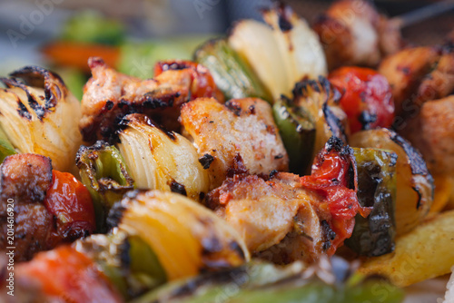 Billede på lærred Grilled meat and vegetables on a skewer at a summer cookout