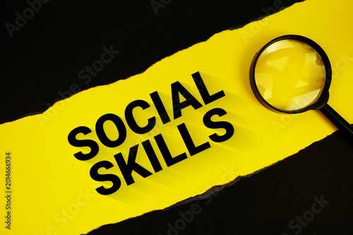Social Skills text on yellow with black paper torn ripped and magnifying glass