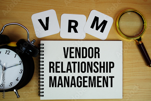 Tableau sur toile VRM Vendor Relationship Management text written on notepad with magnifying glass