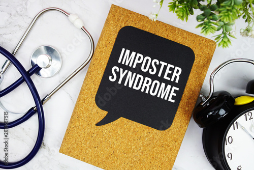 Schilderij op canvas Imposter Syndrome text with stethoscope and alarm clock on marble background