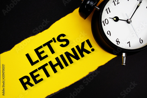 Fotografie Let's Rethink! with alarm clock on yellow background