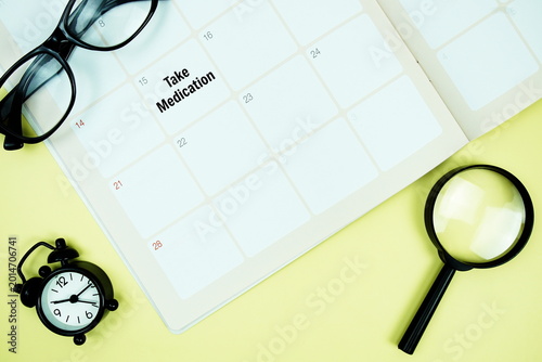 Schilderij op canvas Take Medication message written on calendar date with alarm clock, glasses and m