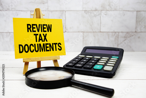 Schilderij op canvas Review Tax Documents text with calculator and magnifying glass