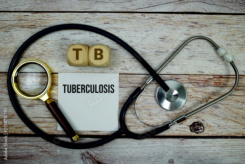 Tableau sur toile Tuberculosis (TB) text with stethoscope and magnifying glass on wooden backgroun