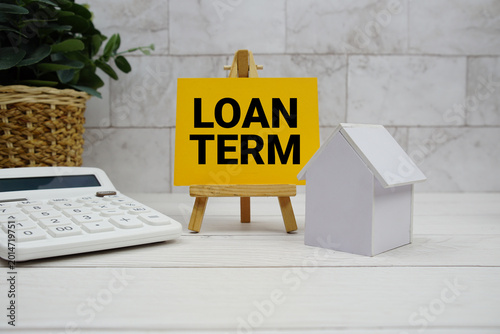 Canvas Print Loan Term text with house model and calculator on wooden background