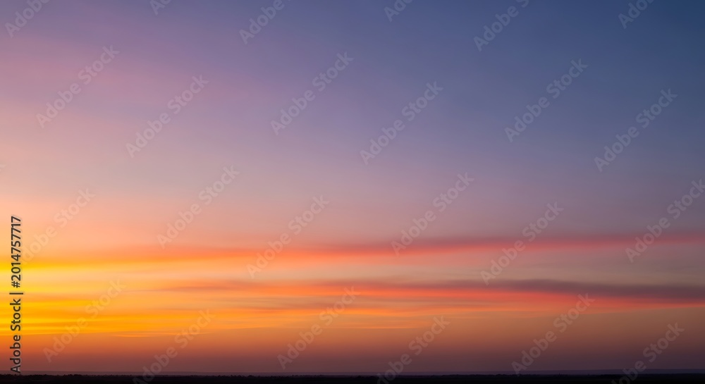 Fototapeta premium Beautiful colorful sunrise sky with vibrant orange and purple hues.