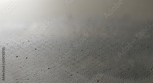 Subtle textured gray concrete wall provides a neutral background for product display or minimalist design.