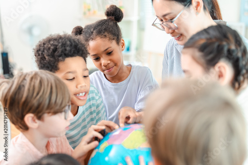 Back to school and education concept of children classroom teacher globe learning together in bright school activity