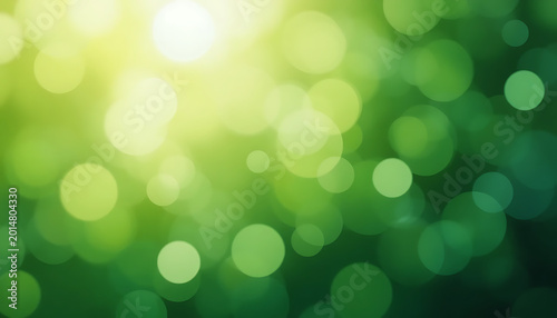 Green bokeh background, with yellow sunlight, gradient of light, and dark green circles