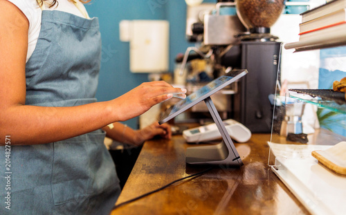 Obraz na płótnie Employee using tablet for a digital point of sale