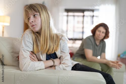 Upset girl ignoring mother after family argument